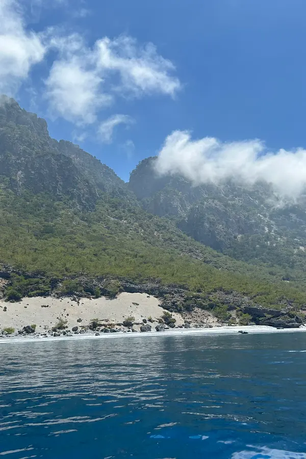 White sand beach meeting calm turquoise waters at Agios Pavlos, a beautiful bay on Crete.